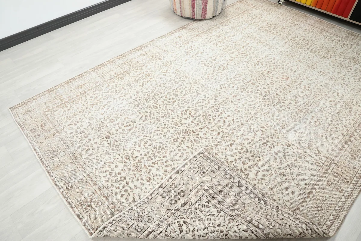 Corner of the rug folded back, revealing the hand-knotted cotton foundation and reverse side.