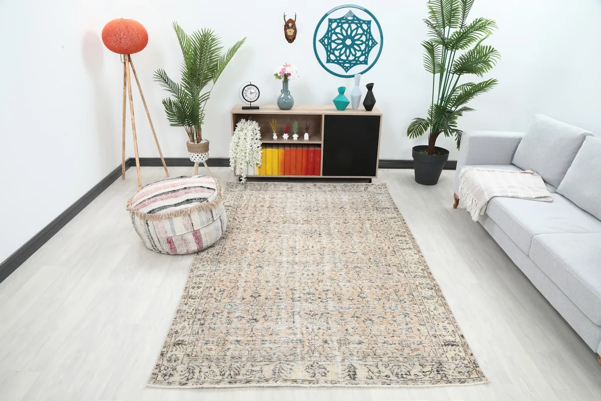 Vintage Anatolian rug in a modern living room setting, viewed from an angle.