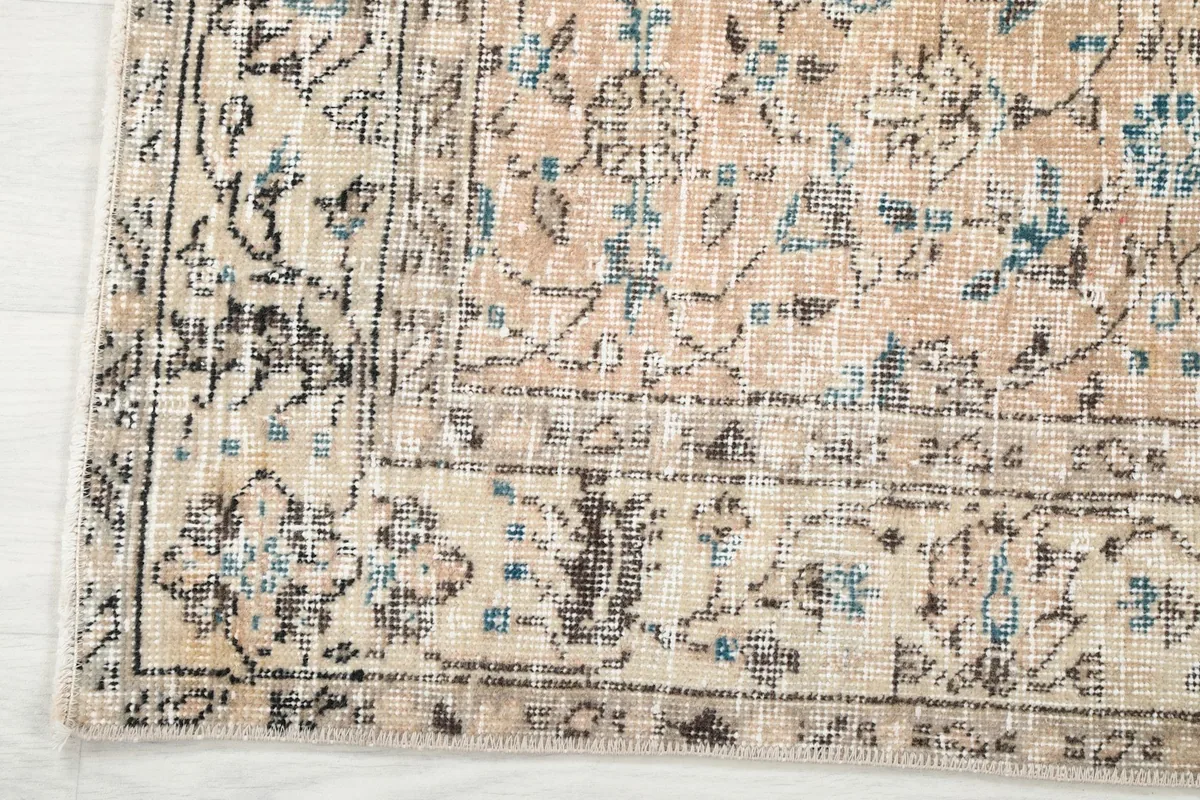 Close-up of the rug's border, showcasing the distinct patterns and colors along the edge.