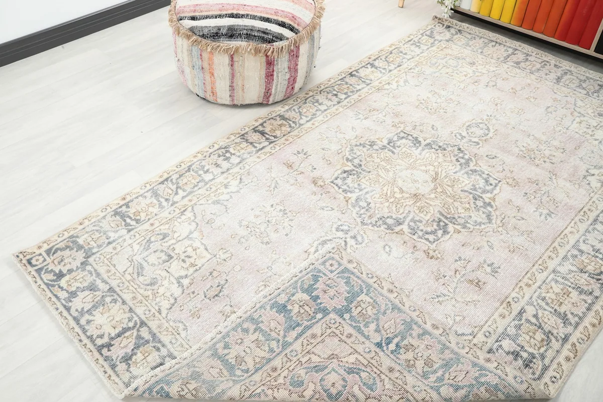 Angled view showcasing the full length and width of the rose vintage rug