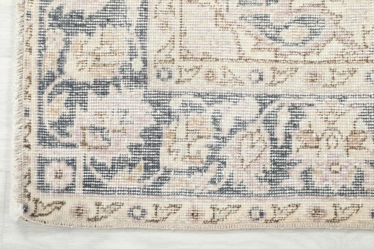 Close-up of the gray and beige border pattern and the rug's edge