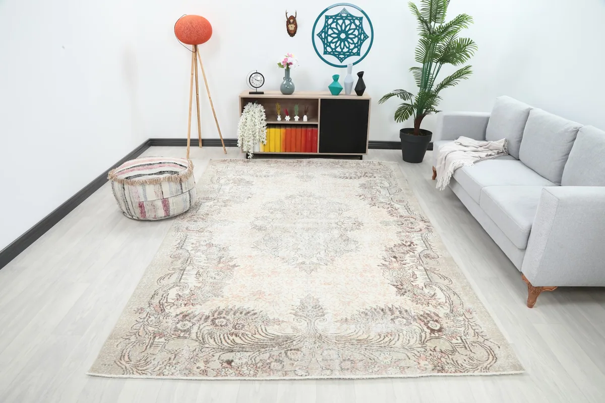 Vintage ivory and rose rug in a living room setting with a light gray sofa and modern decor
