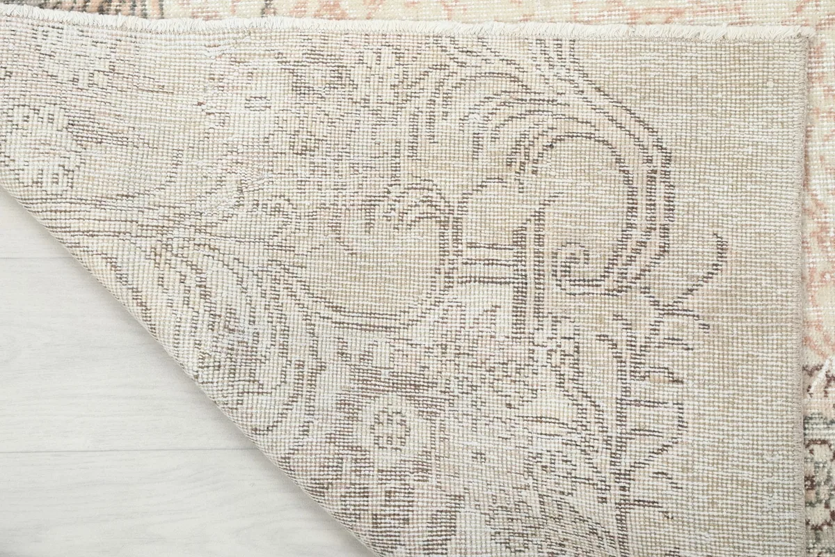 Underside of the rug, revealing the intricate hand-knotted structure and cotton foundation
