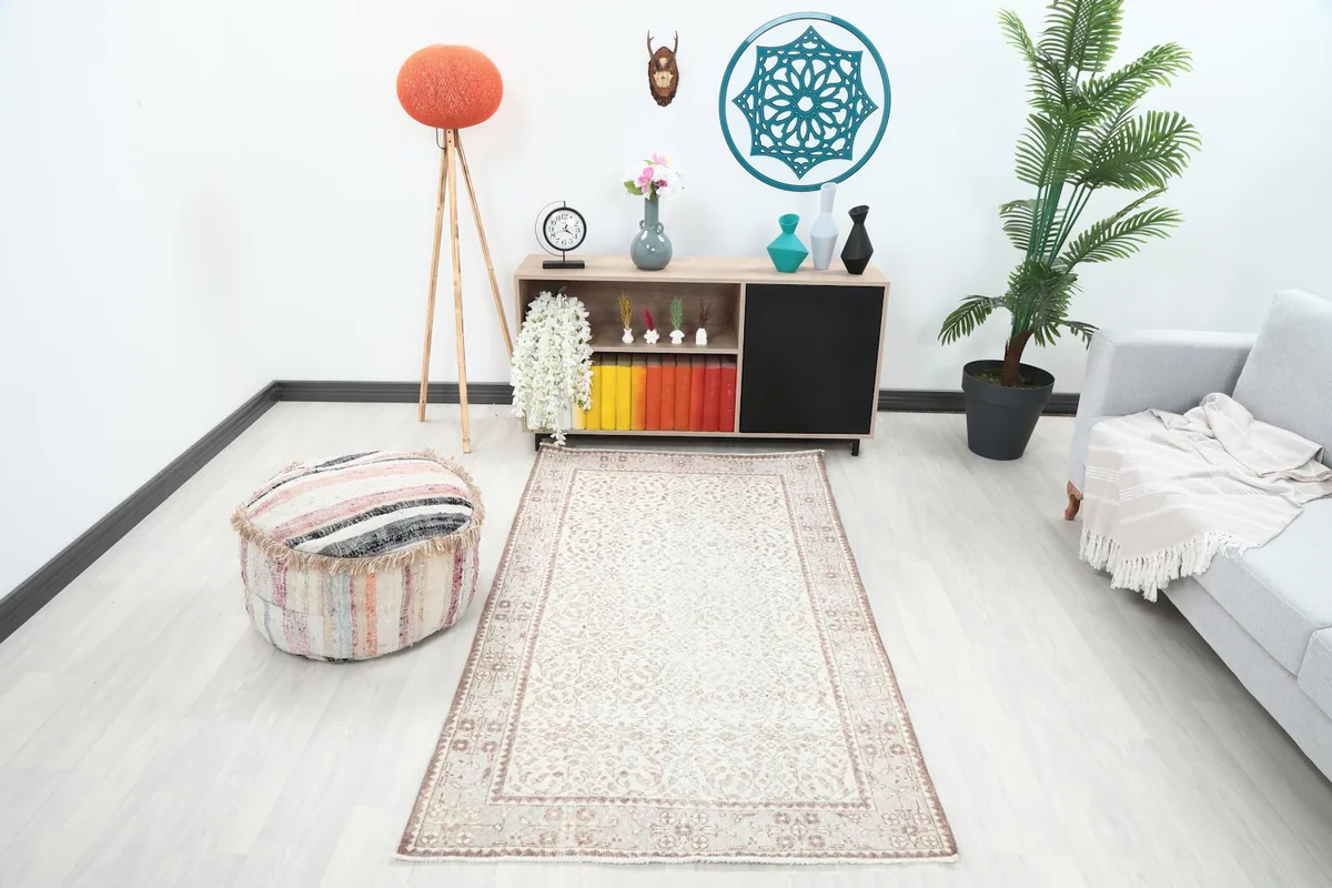 Vintage ivory and rose rug in a modern living room setting with a light gray sofa