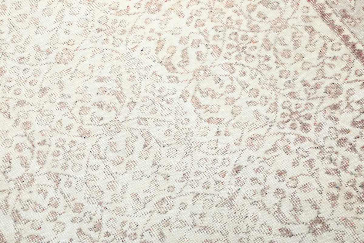 Detailed close-up of the hand-knotted wool pile and the intricate floral motifs
