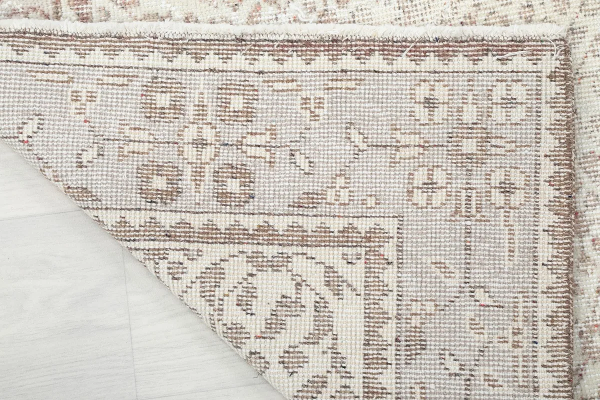 Close-up of the back of the rug, revealing the hand-knotted construction and cotton foundation