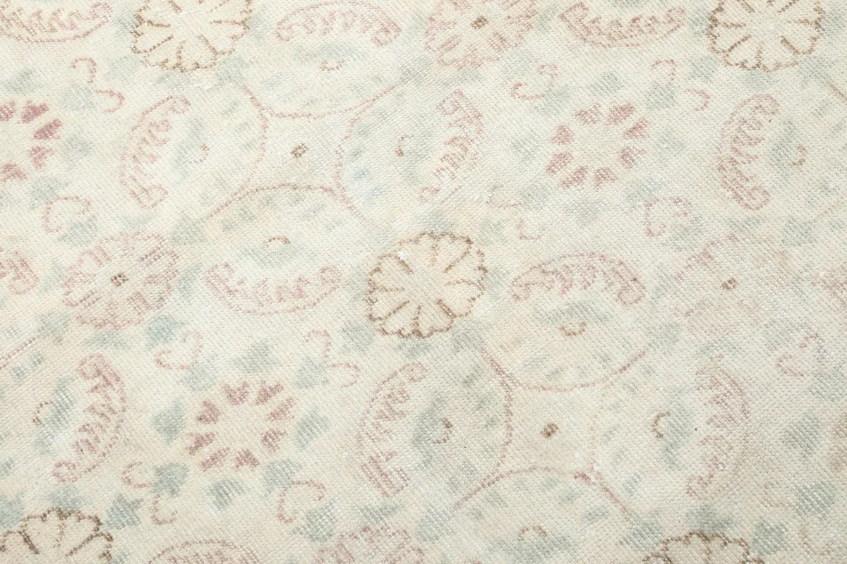 Detailed view of the hand-knotted wool pile and intricate floral patterns