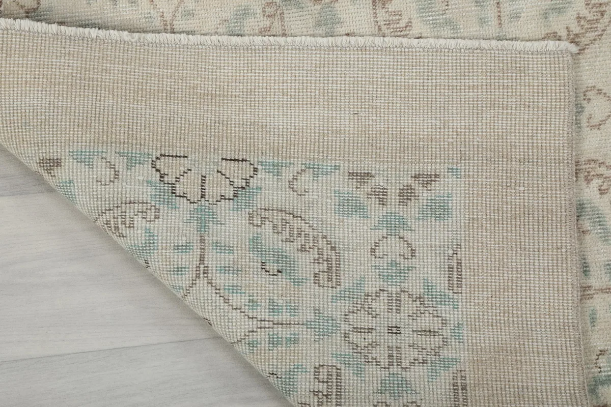 Underside of the rug showing the cotton foundation and knotting