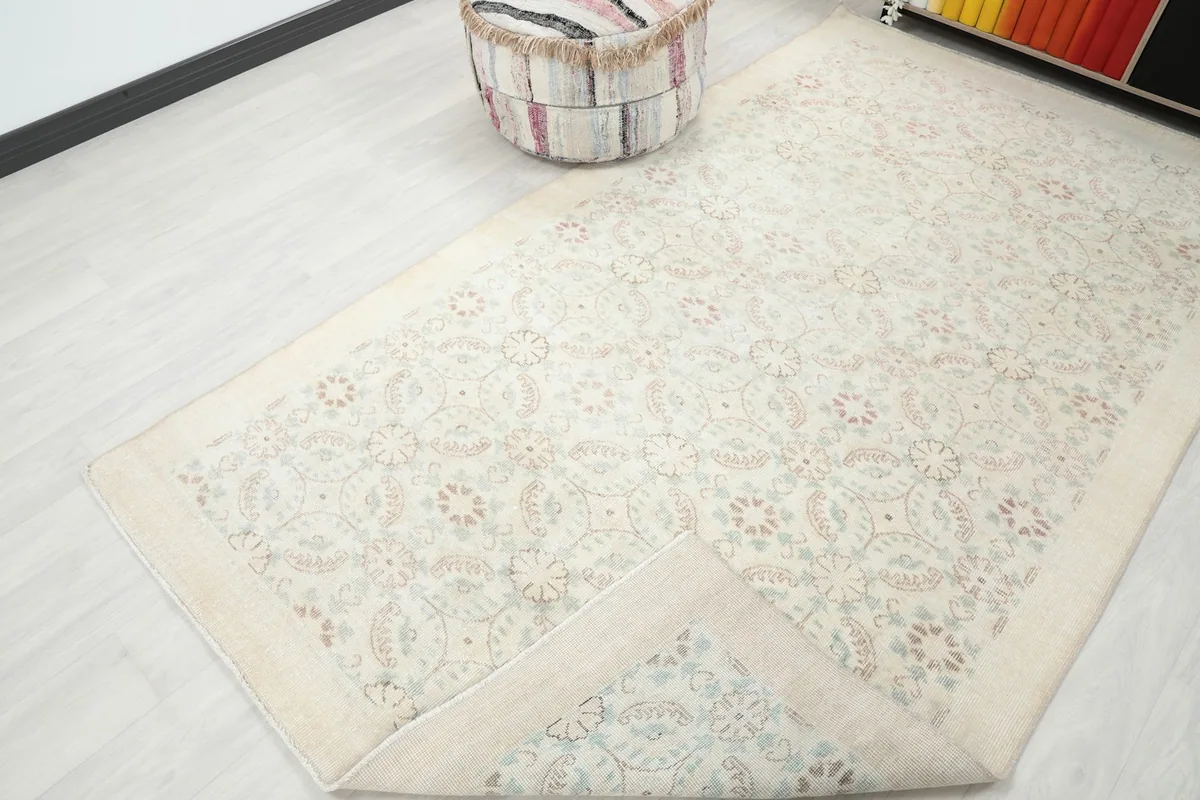 Corner of the rug folded back to reveal the cotton foundation