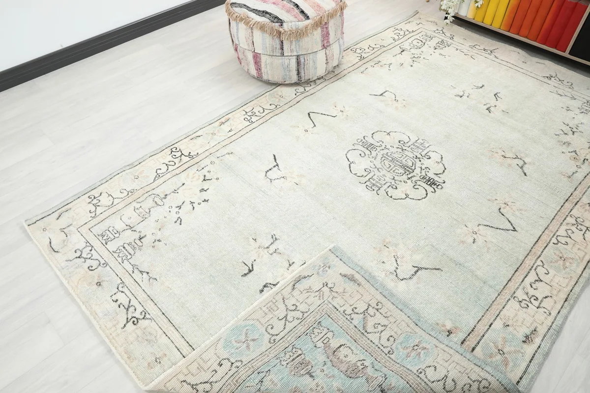 The rug partially folded back, revealing a glimpse of the underside and the full design from an angle.