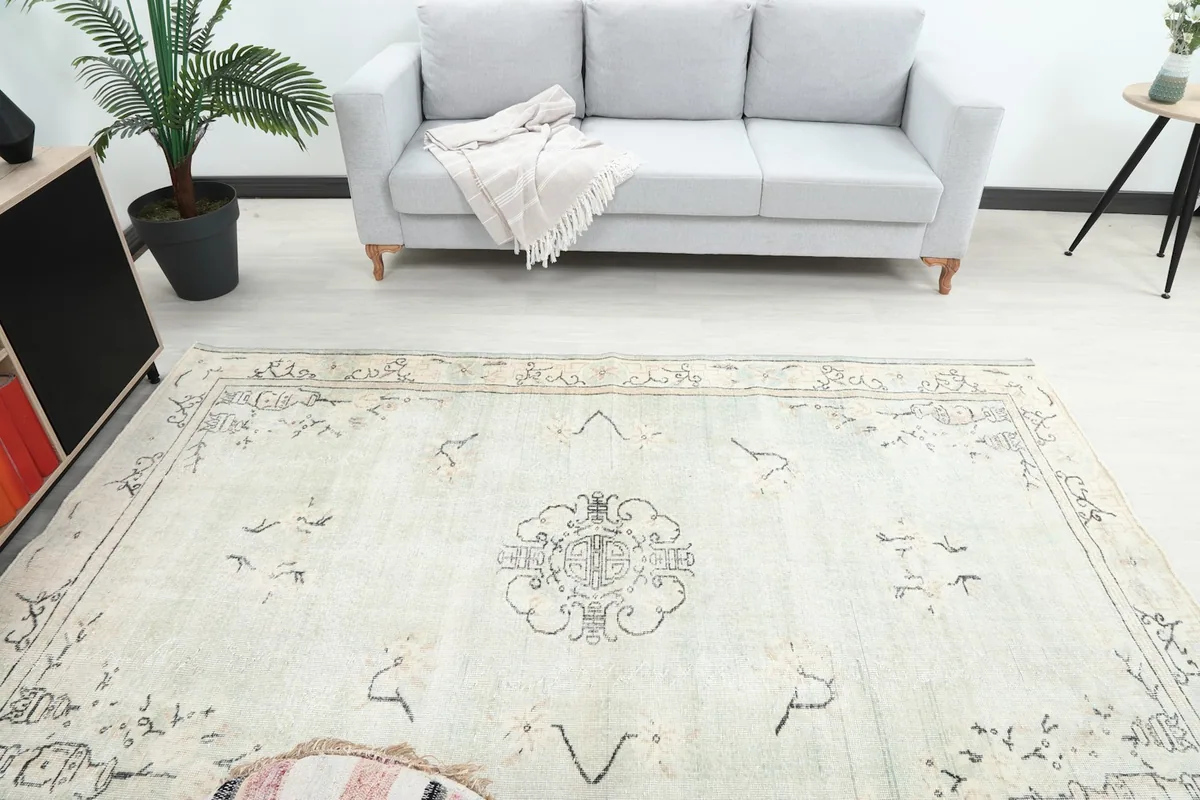 Overhead view of the rug in a room, highlighting the central medallion and overall pattern.