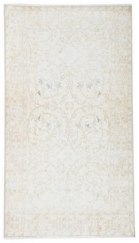 Full overhead view of the 3'8" x 6'8" vintage Anatolian area rug with ivory and beige floral patterns