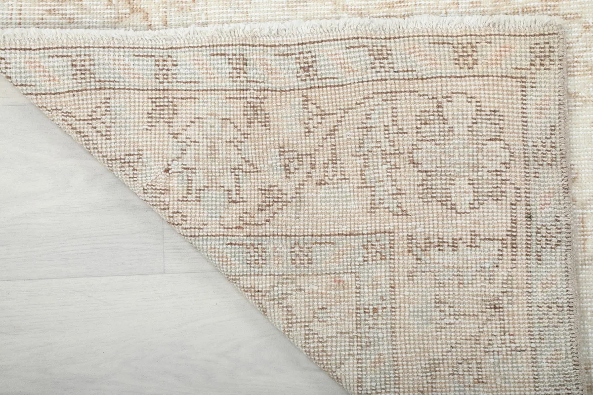 View of the rug's underside, revealing the hand-knotted cotton foundation and tight weave