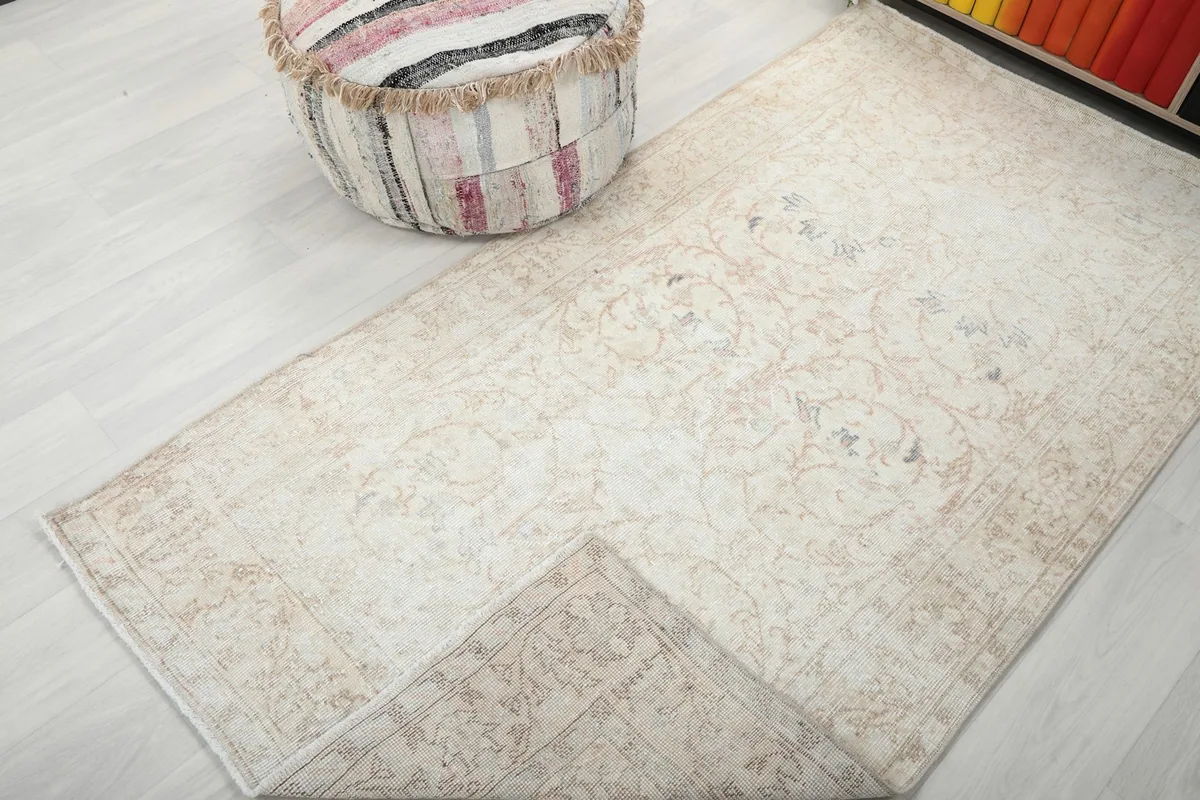 Corner of the rug folded back, showing the consistent pattern and condition on the reverse side