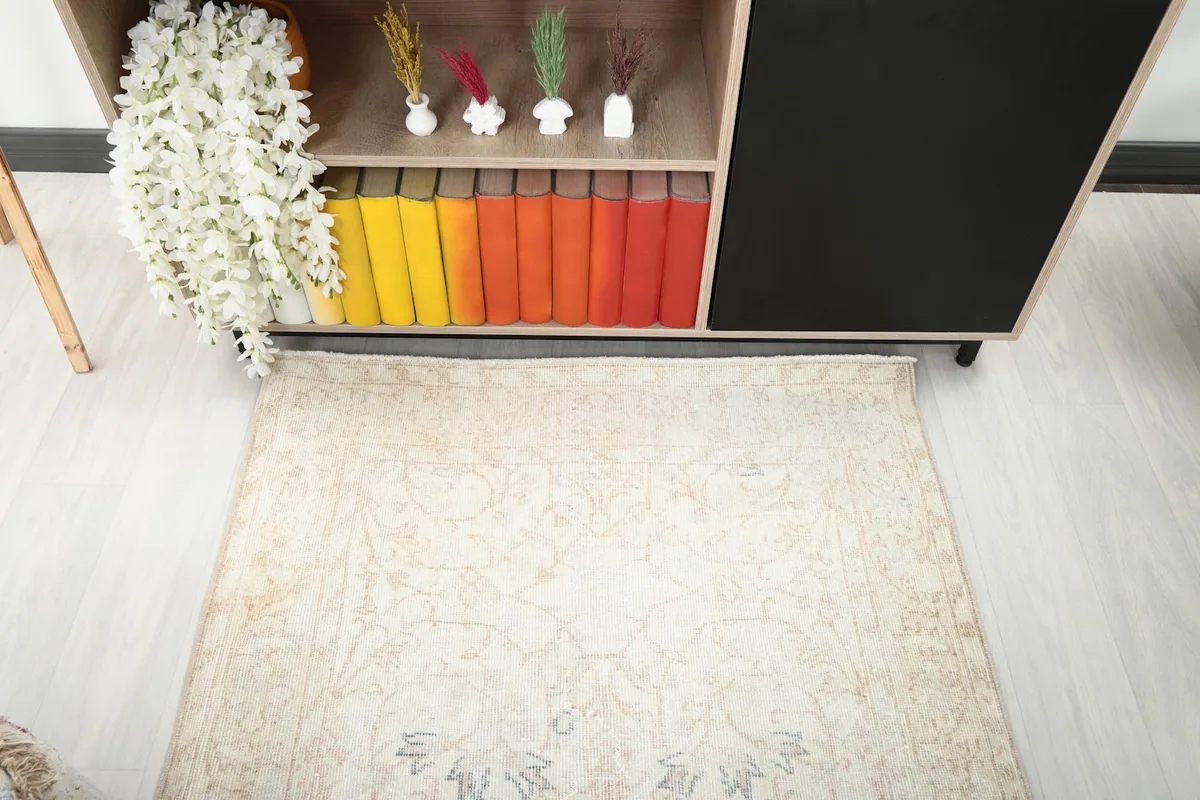 Overhead view of the rug's top half, showcasing the faded floral patterns and soft color palette