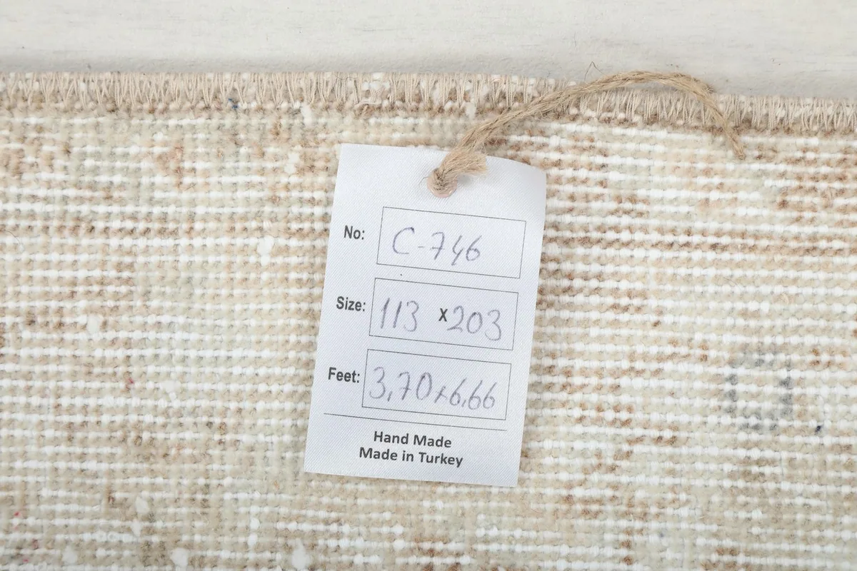 Product tag with size information and 'Hand Made in Turkey' attached to the rug's edge
