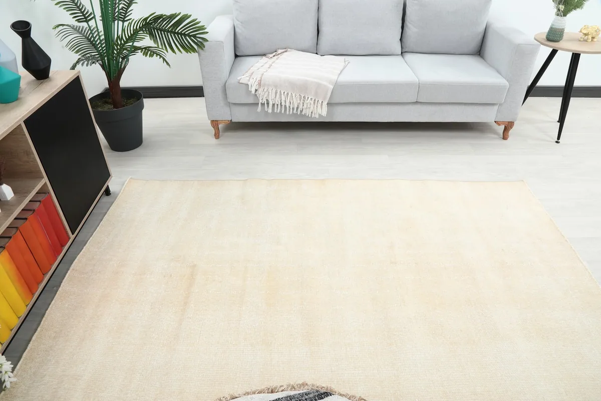 Overhead view of the ivory rug in a living room, showing its placement relative to furniture.