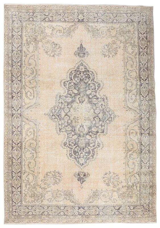 Full overhead view of the beige and gray medallion vintage Anatolian rug on a white background