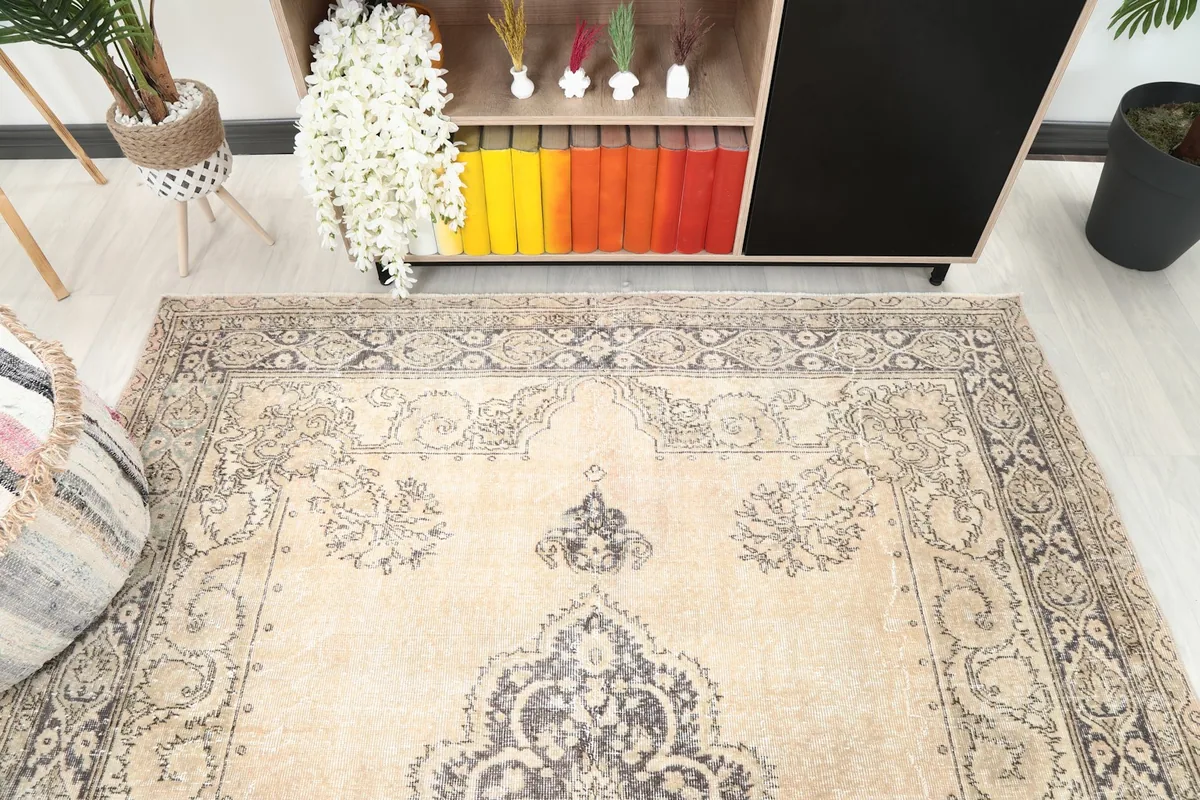 Detail view of the rug's border and central motif in a room setting