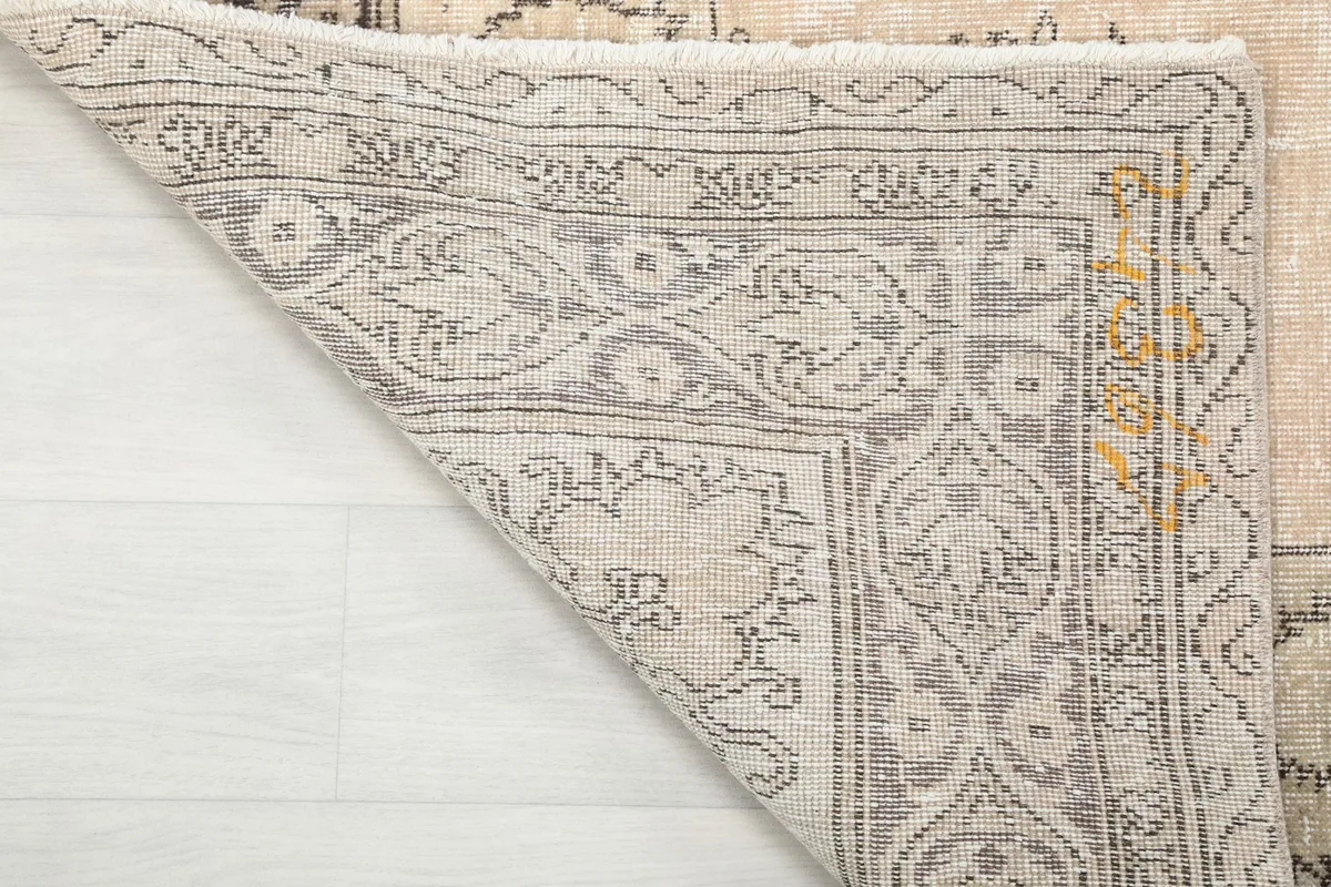 Close-up of the back of the hand-knotted rug, revealing the cotton foundation and knotting
