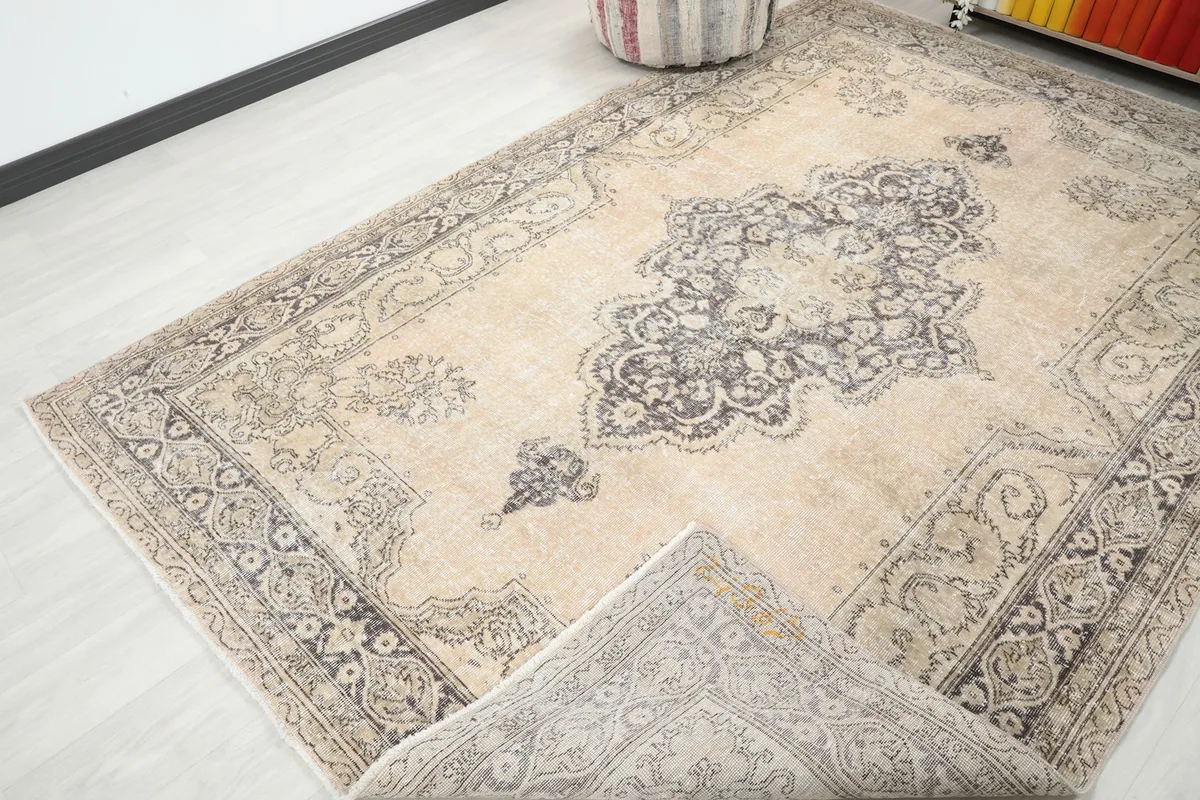 View of the rug folded back to show the reverse side and construction near the edge
