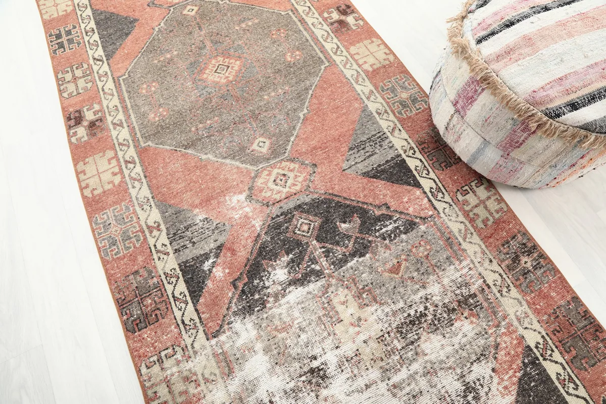 Diagonal view of the runner rug, emphasizing the blend of rust, gray, and black tones and tribal patterns.