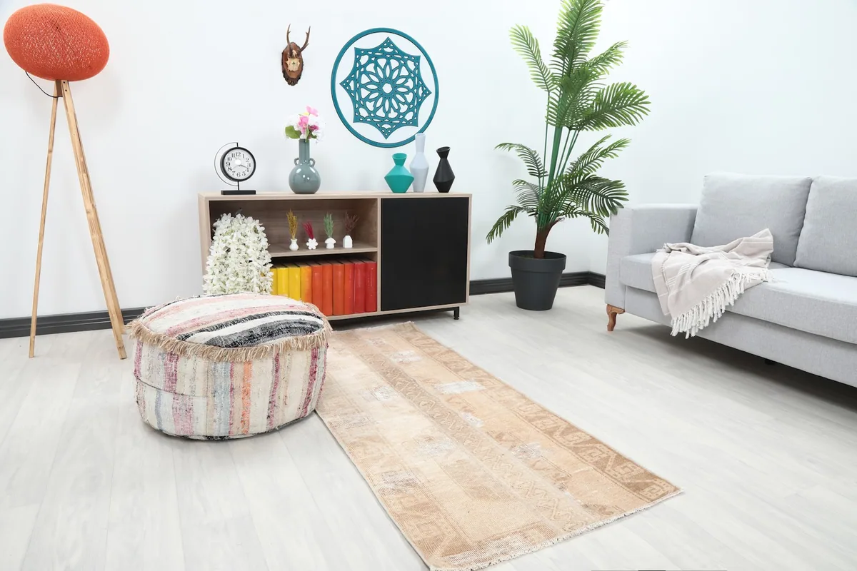 Angle view of the beige runner rug in a room, highlighting its color against light flooring