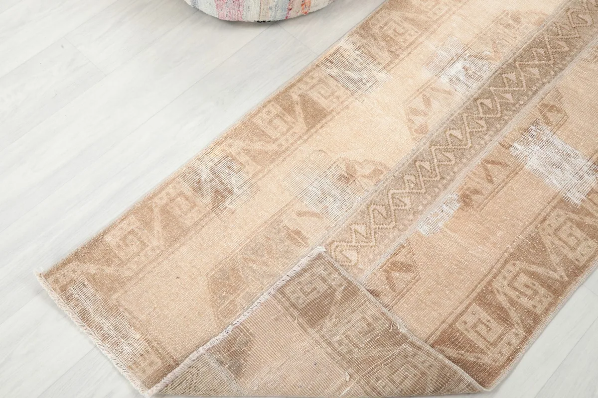 Partial fold of the rug showing the pile and the cotton foundation underneath