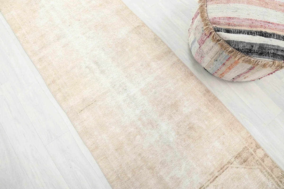 Diagonal view of the runner rug's texture and subtle color variations on the floor