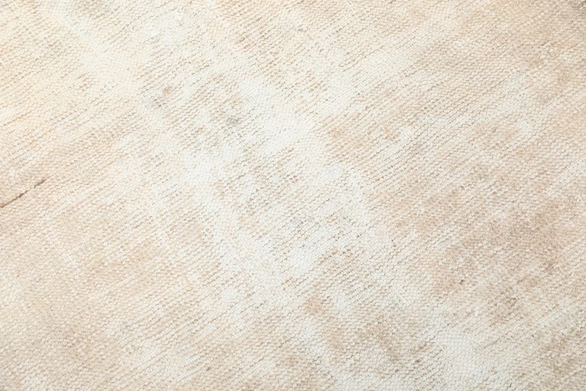 Close-up of the low wool pile, showing the distressed texture and woven knots
