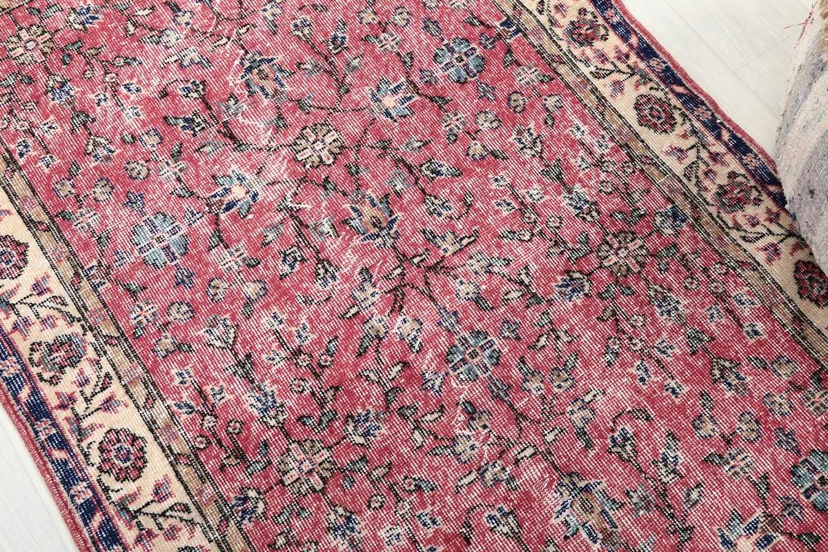 Detailed view of the rose field with blue and navy floral patterns and visible patina.