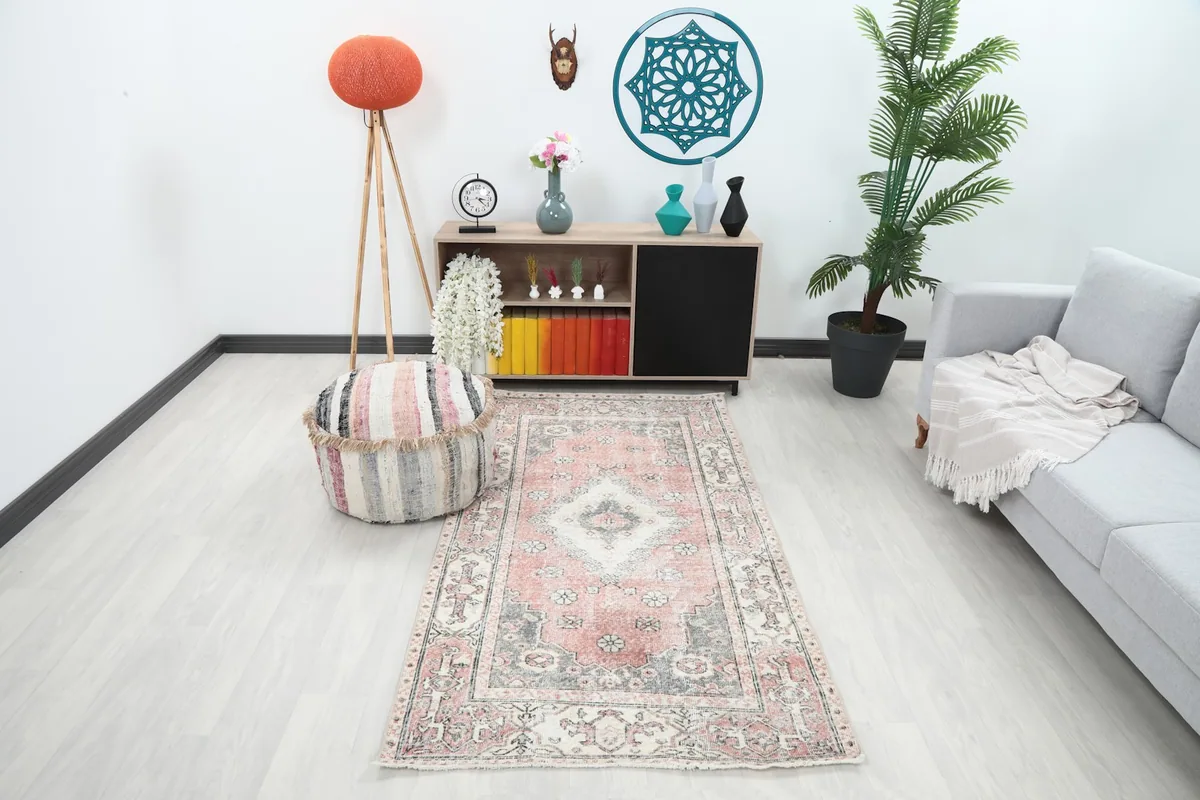 Vintage Anatolian rug displayed in a modern room with a light sofa and wooden furniture