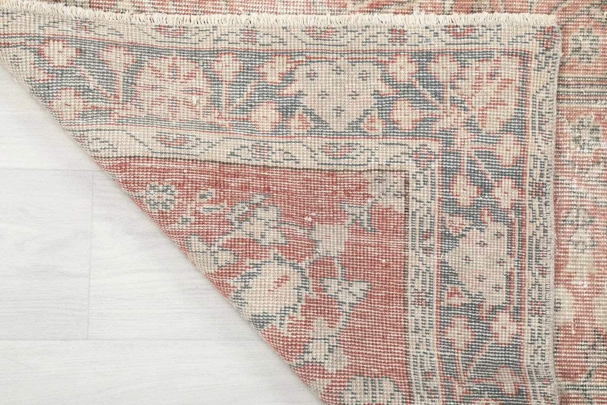 Underside of the rug showing the cotton foundation and fine hand-knotted wool construction