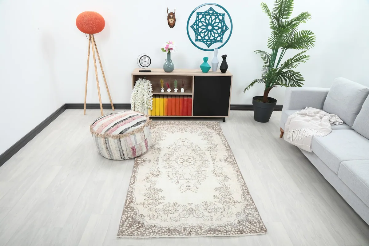 Vintage cream and brown area rug in a modern living space with light-colored furniture