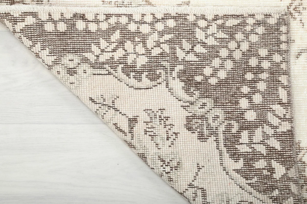 Close-up of the rug's back, revealing the hand-knotted construction and foundation