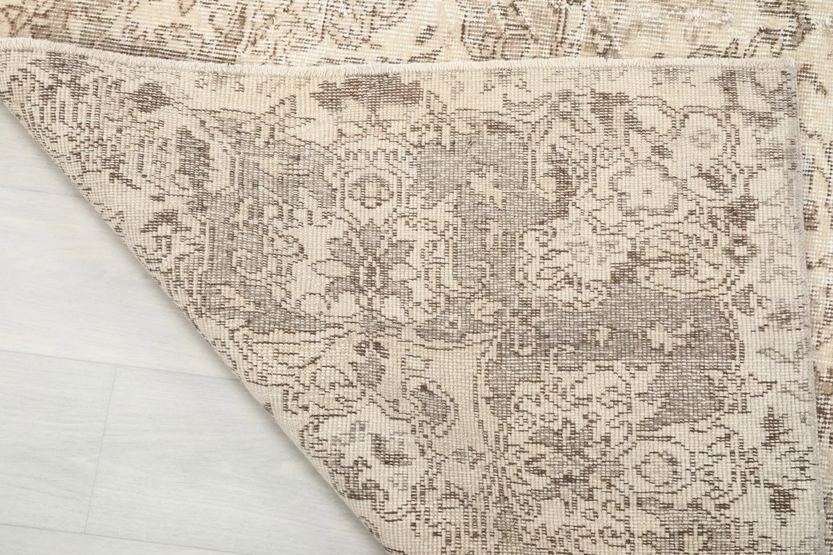 Detail of the rug's reverse side, showcasing the hand-knotted cotton foundation.