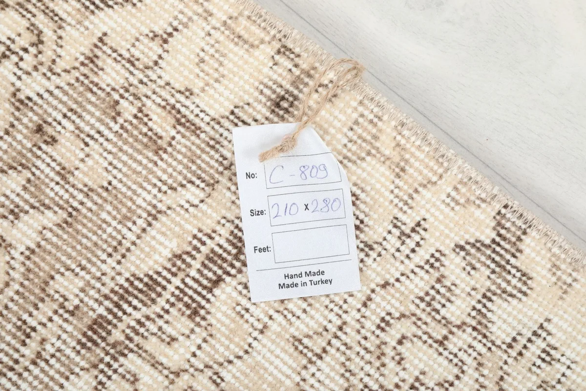 Tag showing the rug's dimensions and 'Hand Made in Turkey' on the reverse side.