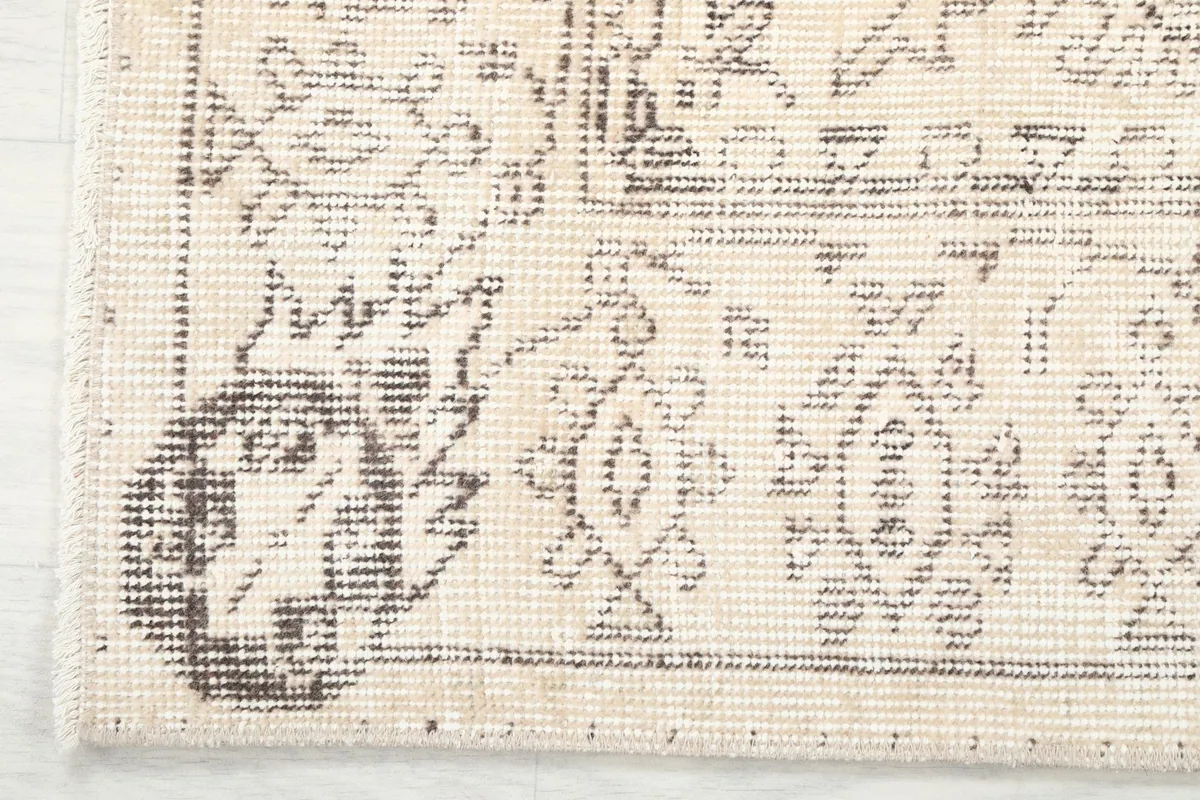 Corner detail showing the rug's border pattern and hand-knotted edge
