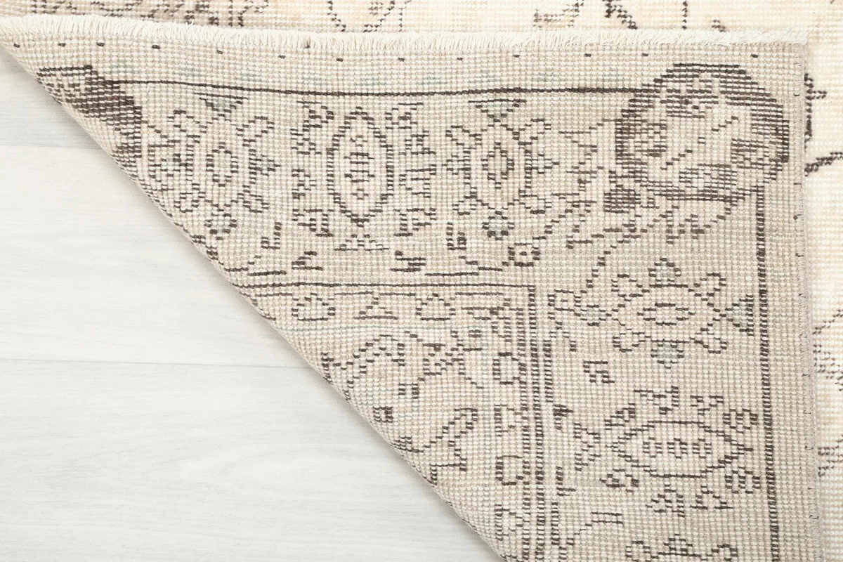 Underside of the rug showing the hand-knotted construction and foundation