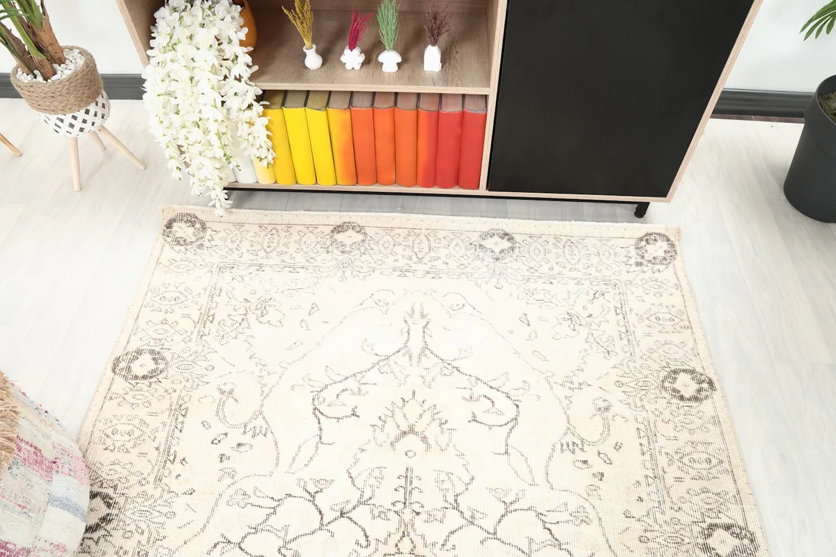 Top-down view of the rug's pattern and texture, showing its faded motifs