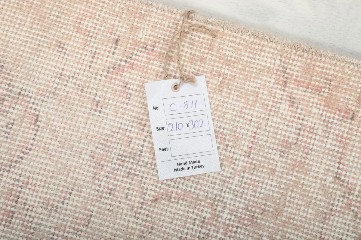Product tag attached to the rug, displaying size information and origin 'Hand Made in Turkey'.