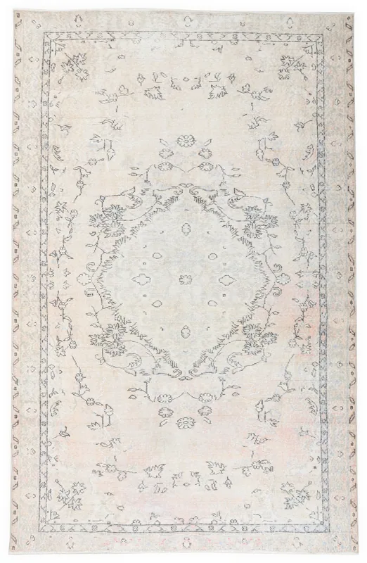 Full overhead view of the 5'7" x 8'7" ivory vintage Anatolian rug with a central floral medallion.