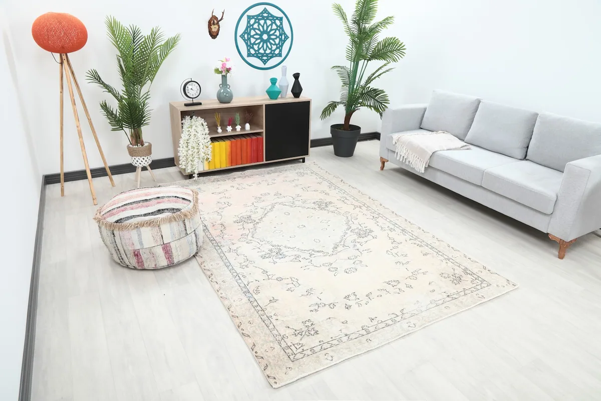 Angle view of the ivory floral medallion rug in a bright room, showcasing its medium size.