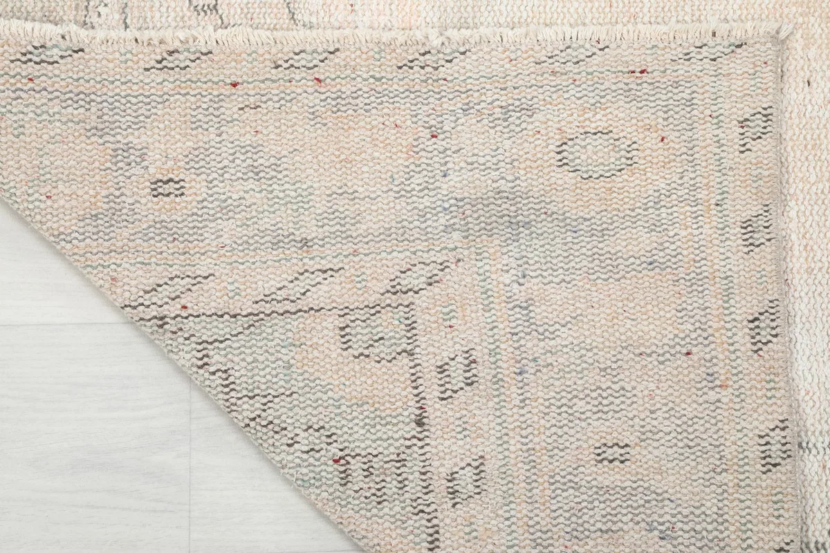 Underside view of the rug, revealing the cotton foundation and the intricate hand-knotting.
