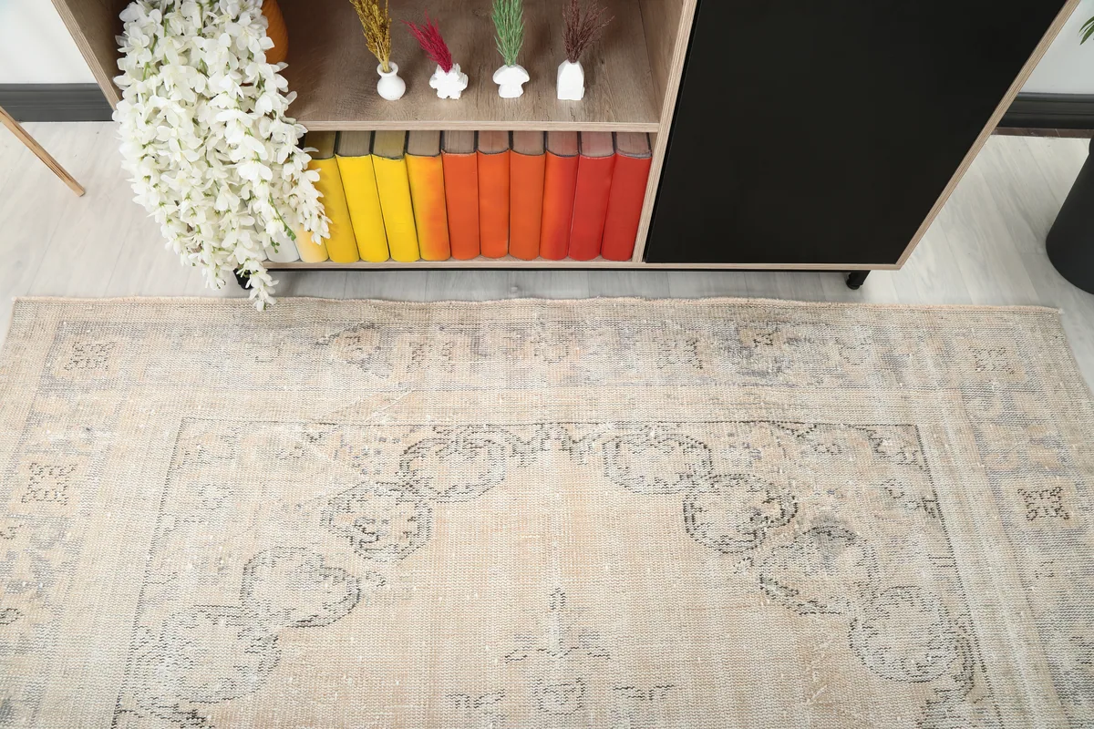 Detailed view of the rug's upper section and border, seen from above a cabinet.