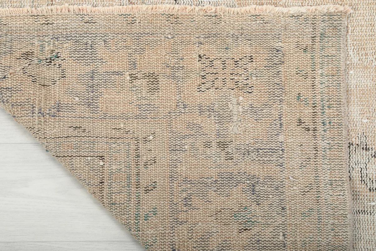 Underside view of the rug, illustrating the hand-knotted wool pile on a cotton foundation.