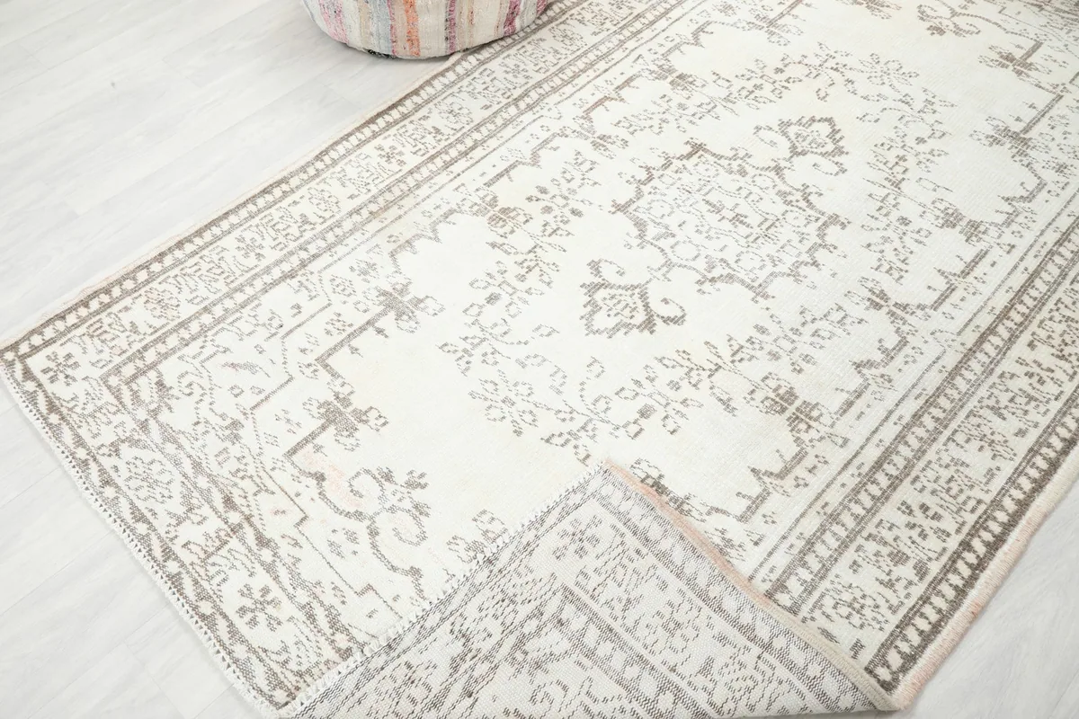 Rug folded to show the back and front texture, displaying the hand-knotted quality