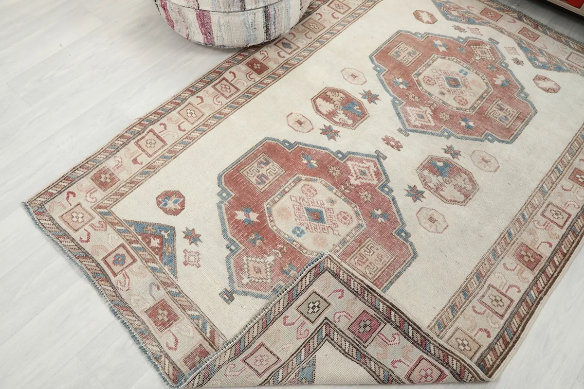 Angled view of the ivory rust geometric vintage rug, highlighting its texture and overall design