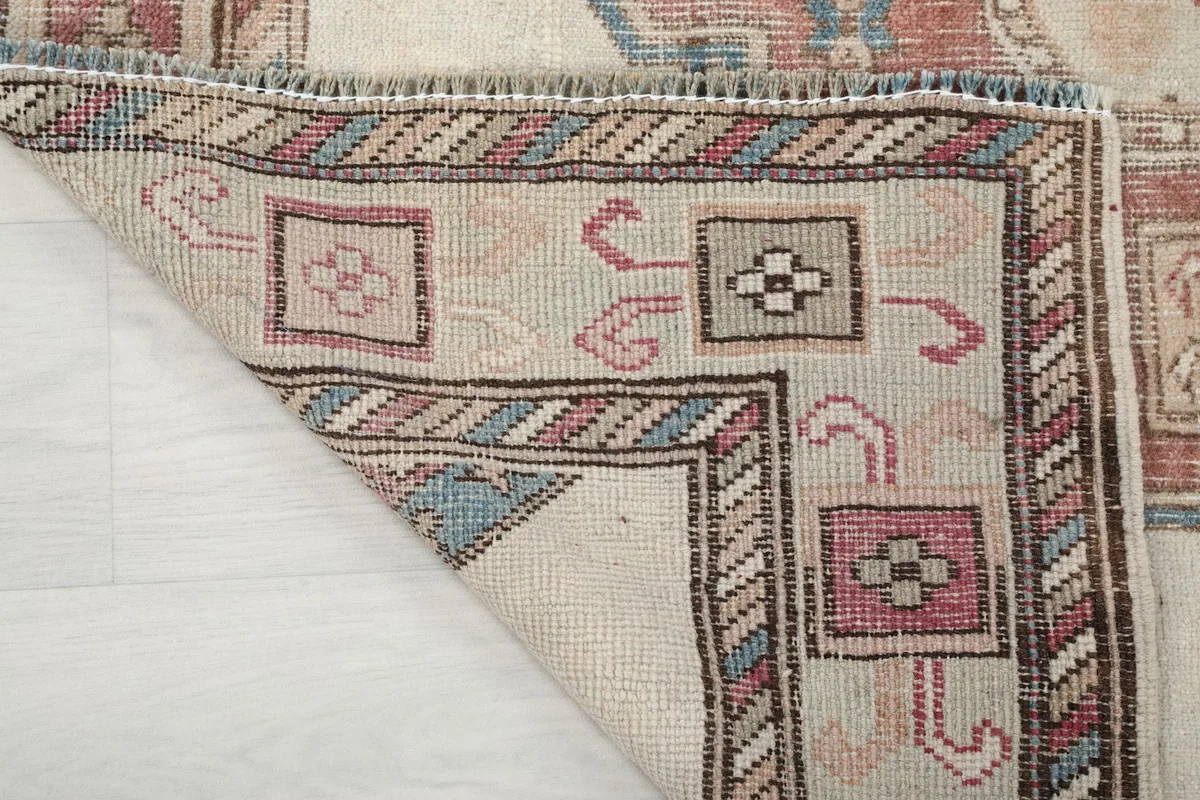 Underside corner of the hand-knotted rug revealing the cotton foundation and construction