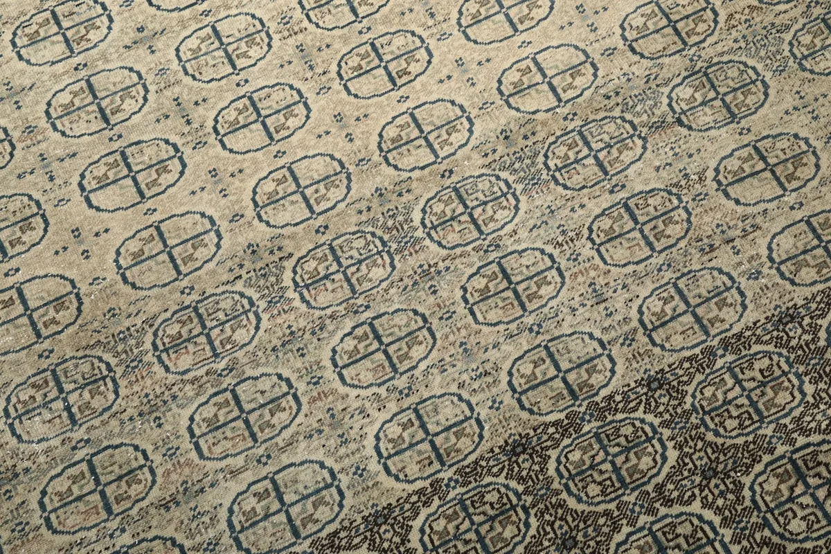 Close-up of the rug's individual geometric patterns and the subtle color shifts within the wool pile.